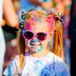 Child in green colors Holi. Holi facial shot on spring color festival of Holi.